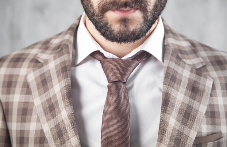 Businessman wearing brown tie and jacket.